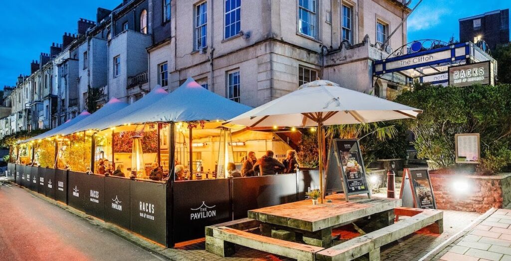 Racks Bar & Kitchen's heated outdoor terrace with guests enjoying BBQ food and drinks in Clifton, Bristol